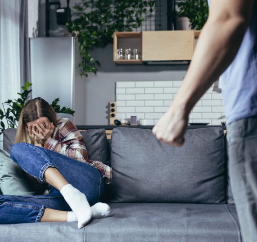 Family quarrel, couple man and woman, domestic violence, family crisis woman sitting on sofa and crying